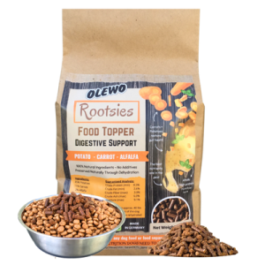 Olewo Rootsies bag behind dog food bowls and a pile of potato, carrot and alfalfa pellets
